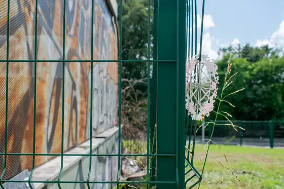 Painted fence panel with a dandelion