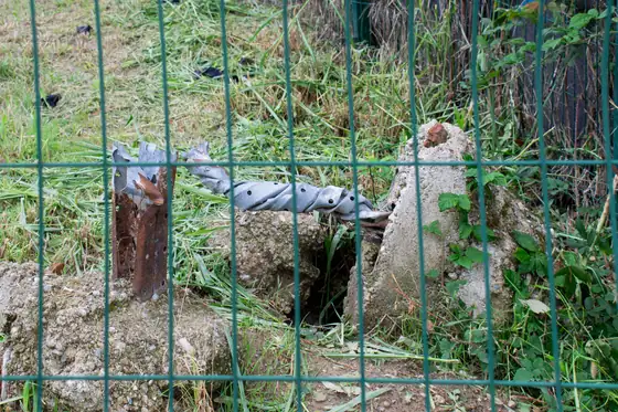 Fence with a pipe and a burrow behind it