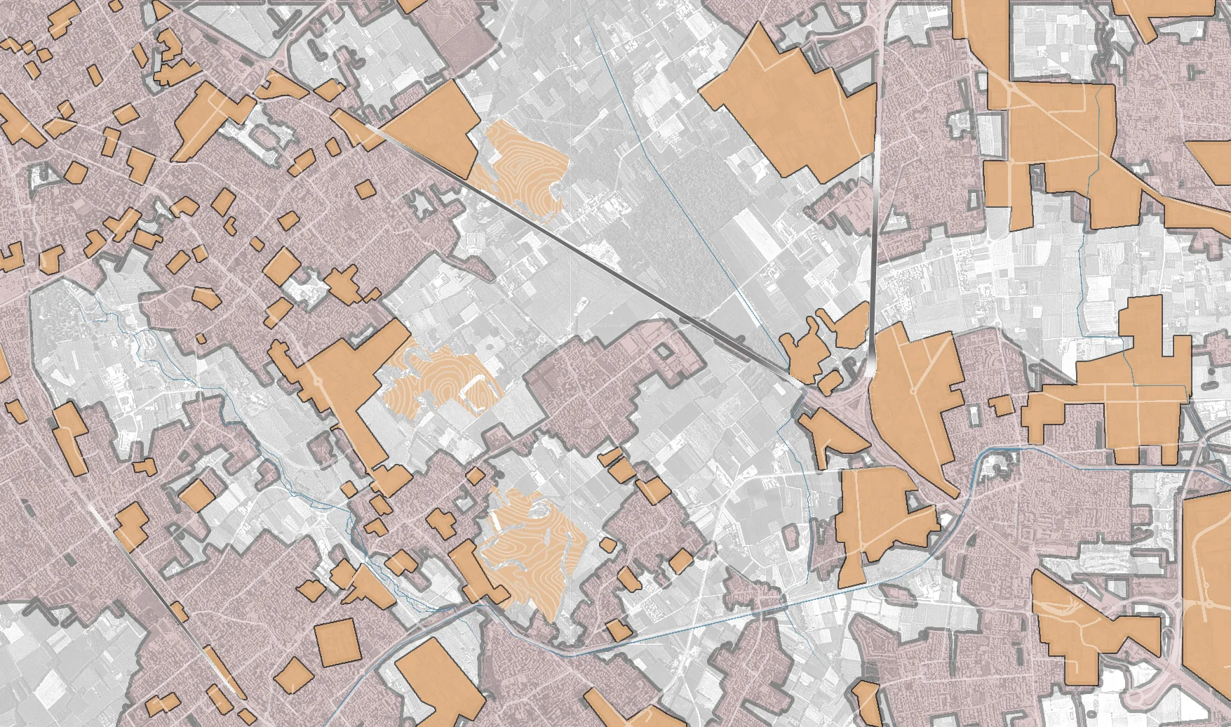 Analysis map in which urban fabric appears in pink and industrial clusters in orange, with a highway and a railway cutting across the territory
