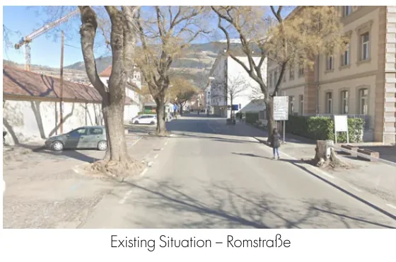 Existing Romstraße with parked cars, mature trees, and institutional buildings